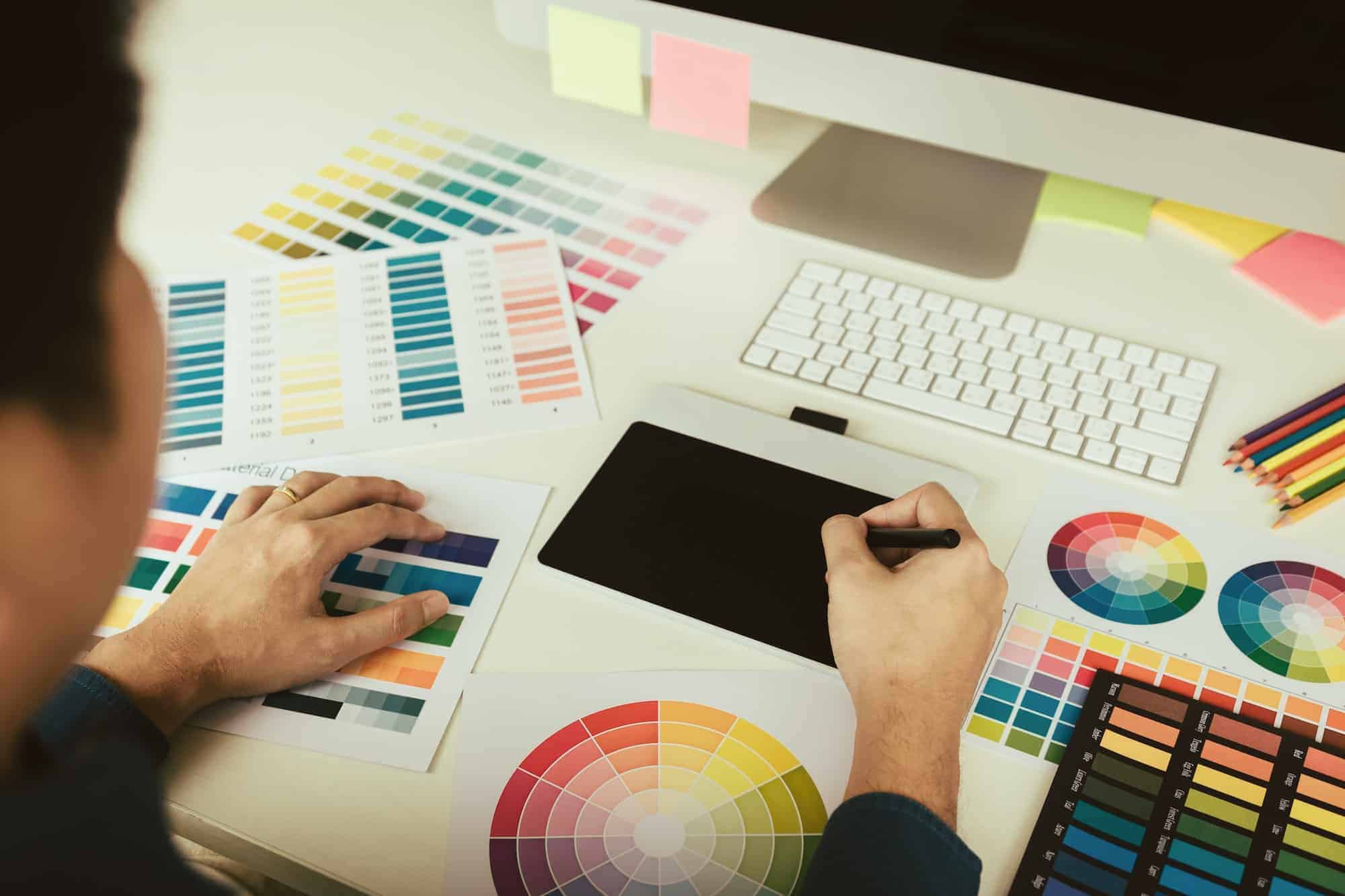Digital artist sketching brand designs on a graphics tablet